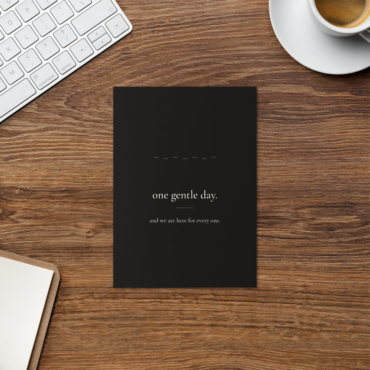 One Gentle Day card on a warm wood desk beside a cup of coffee and a keyboard.