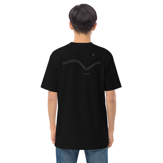 Person wearing the black love stays. The Held Line Tee, back view showing the cream Held Line drawing of two lines through a valley
