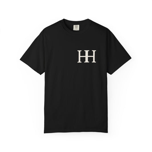 Mockup: front of the black Heavy tee (Comfort Colors 1717) with the ivory HH mark on the left chest