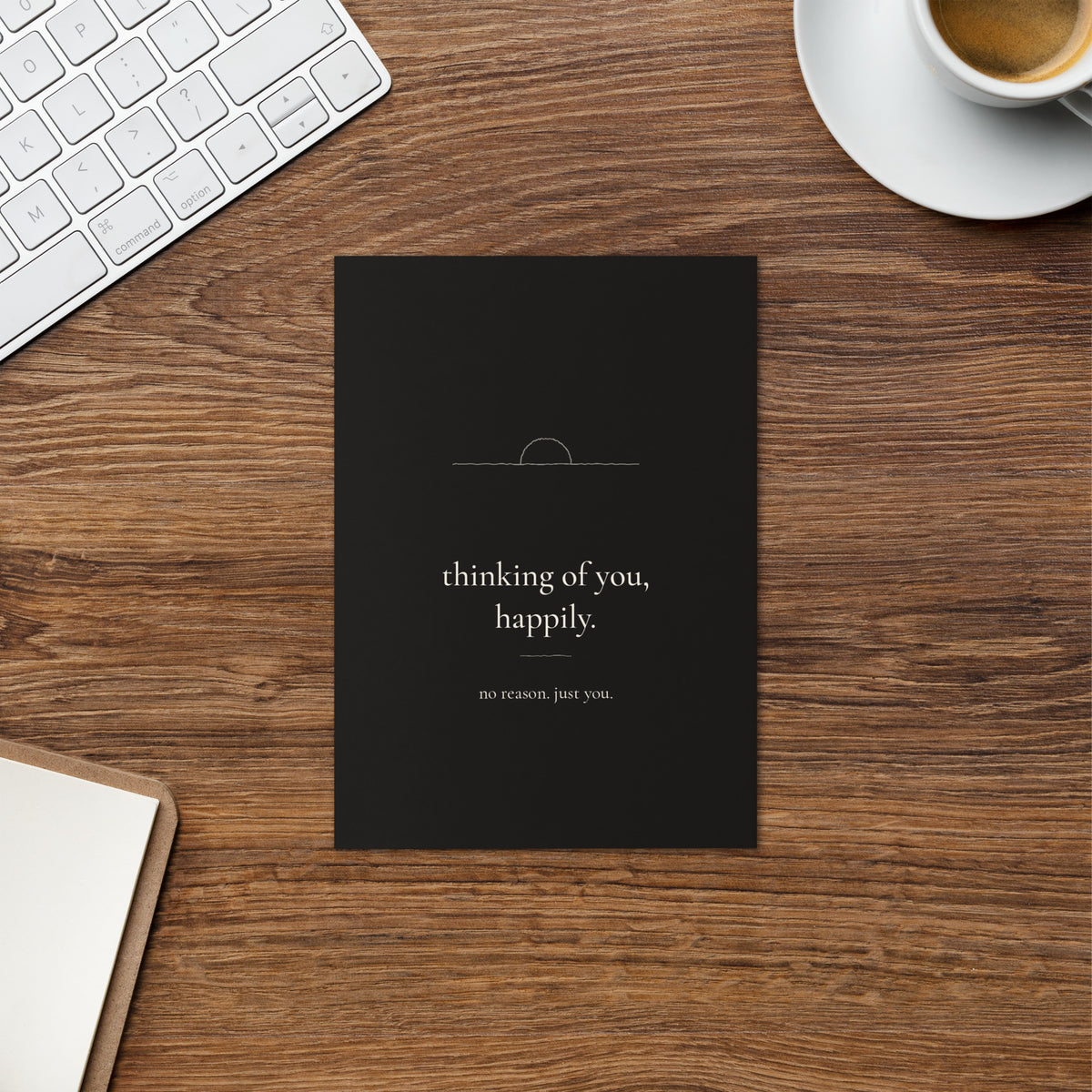 Thinking of You, Happily card on a warm wood desk beside a cup of coffee and a keyboard.