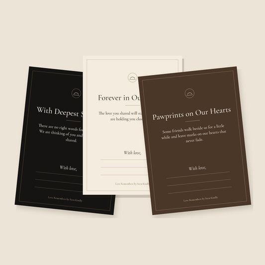 Three printable pet loss cards from the Love Remembers set in cream, black and deep brown, with quiet serif type: Forever in Our Hearts, With Deepest Sympathy, and Pawprints on Our Hearts, each with space to write a few words.