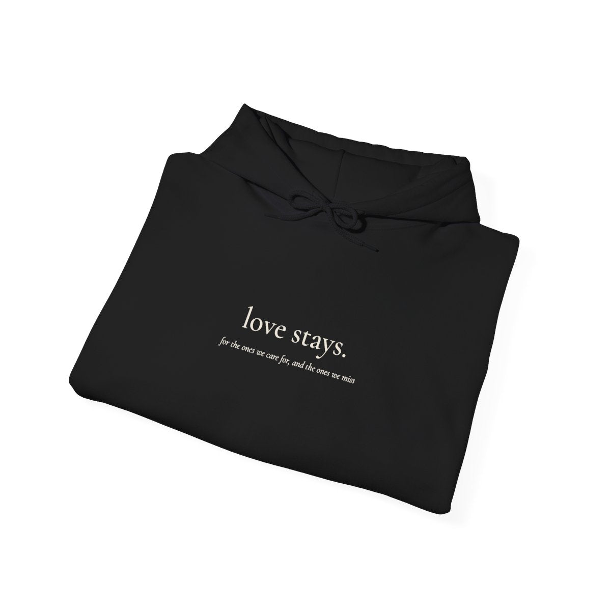 love stays. hoodie in black, folded, showing the cream chest print. Print mockup.