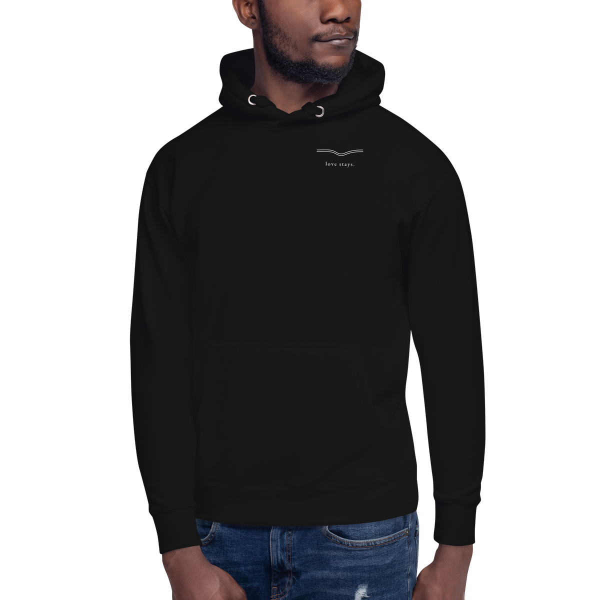 Close on-model front view of the black love stays. The Held Line Hoodie with the small love stays. mark on the chest